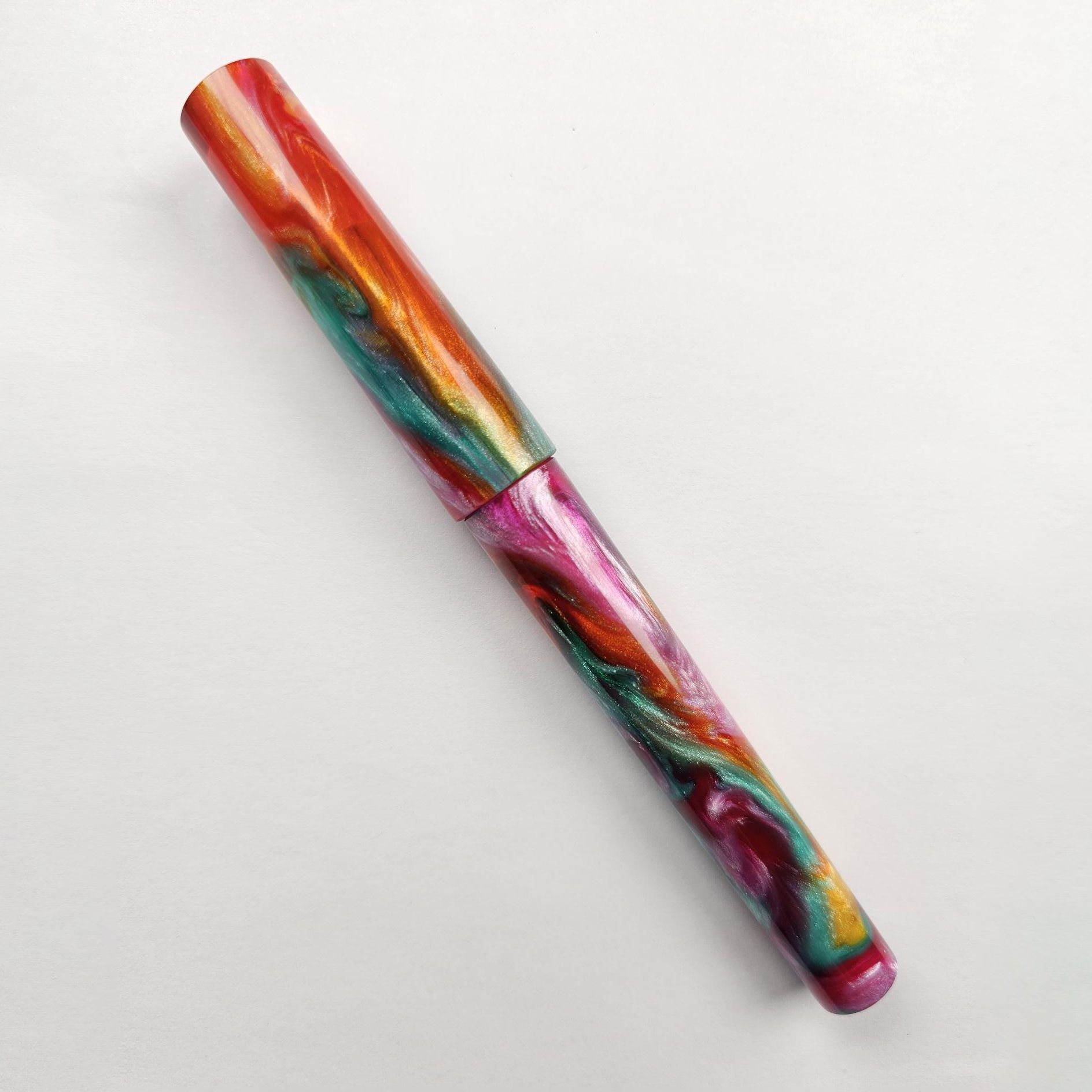 vibrant multi-coloured rainbow coloured fountain pen with cap on