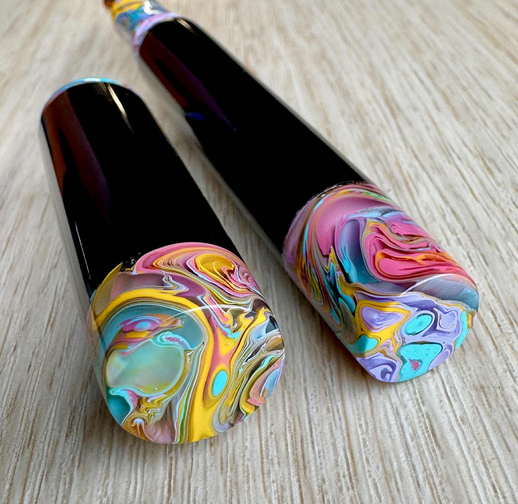 Close up of rainbow finials of a fountain pen