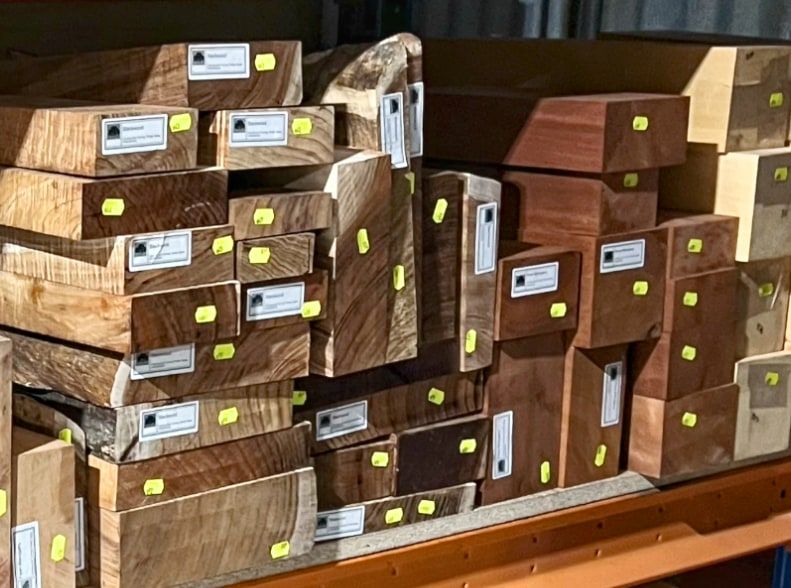 a stack of brightly coloured and textured wooden beams