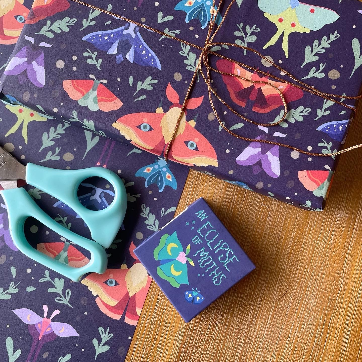 Washi taoe and matching wrapping paper featuring moths and butterflies on a moody navy background