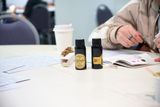 Two bottles of Robert Oster ink sit on a table next to a visitor's open notebook, with ink swatches on the page.