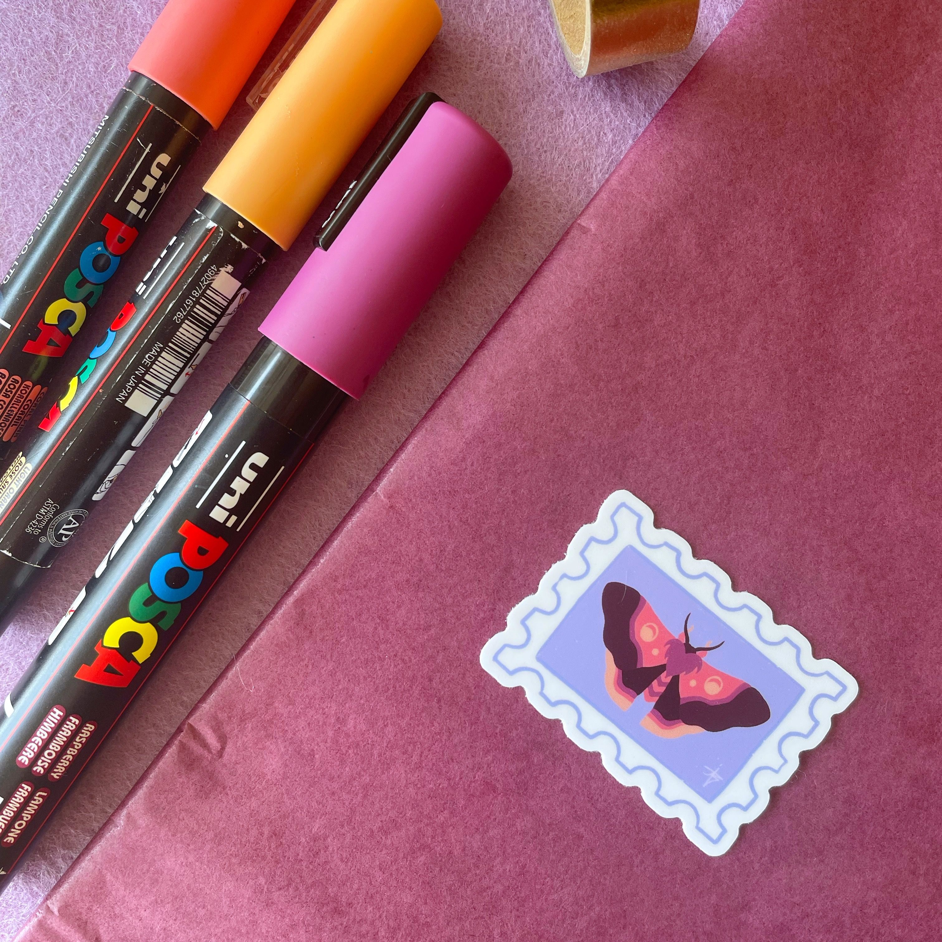 Purple moth themed sticker with some Posca paint pens