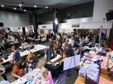 A wide view of the busy show floor from above