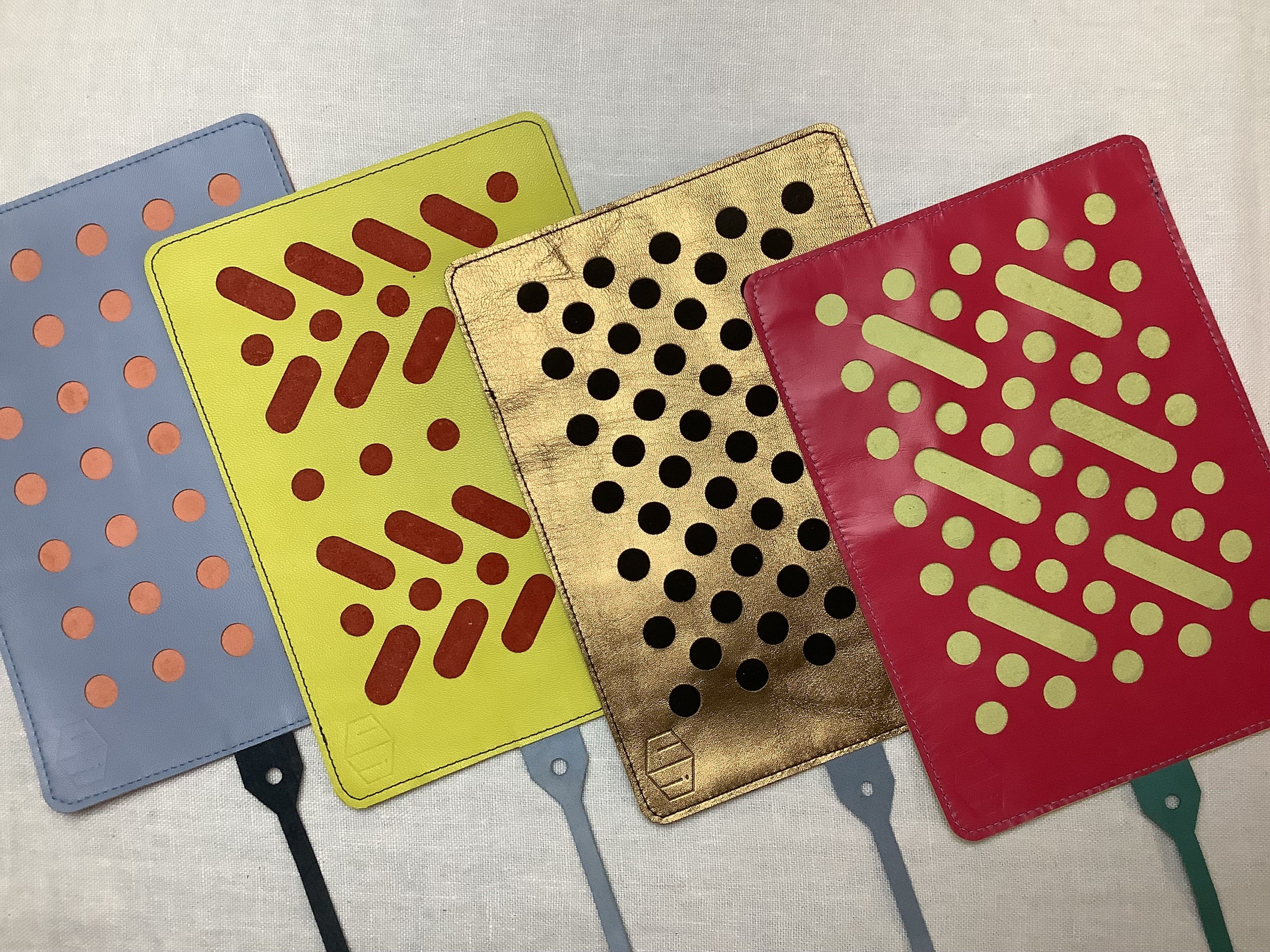 Four brightly-patterned pencil rolls