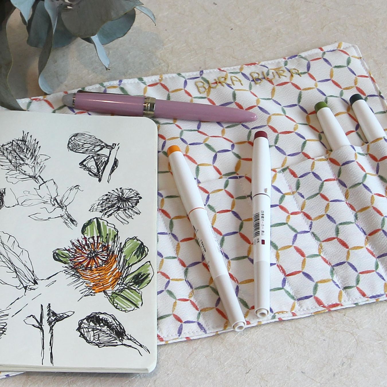 multi coloured hexagon pattern recycled kimono pen warp with pens and a notebook