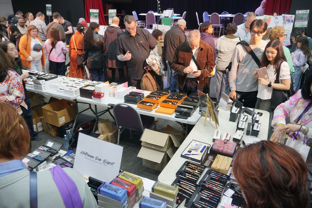 The bustling crowd moves past the Melbourne Pen Depot table