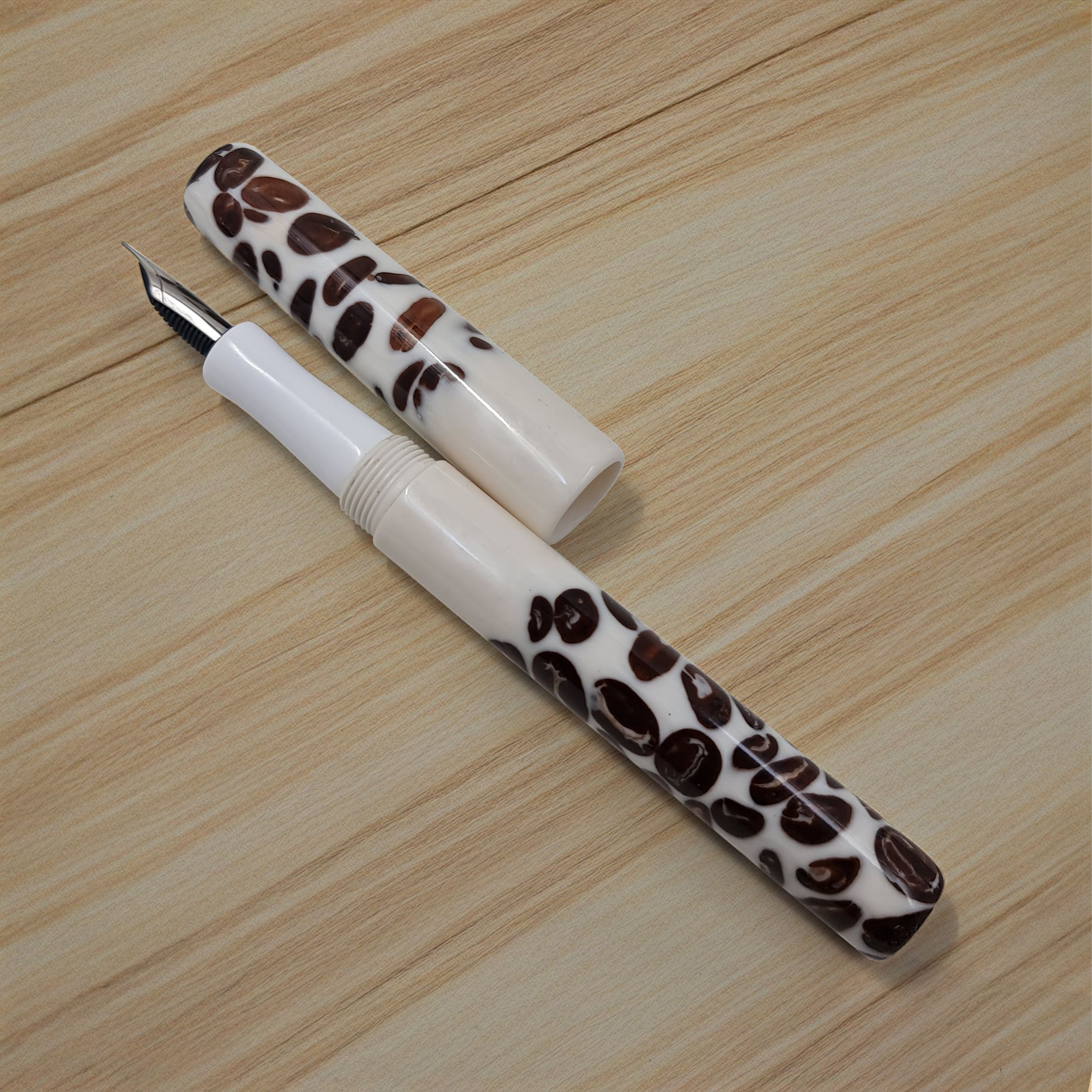Resin white and brown fountain pen that looks like it's make from coffee beans