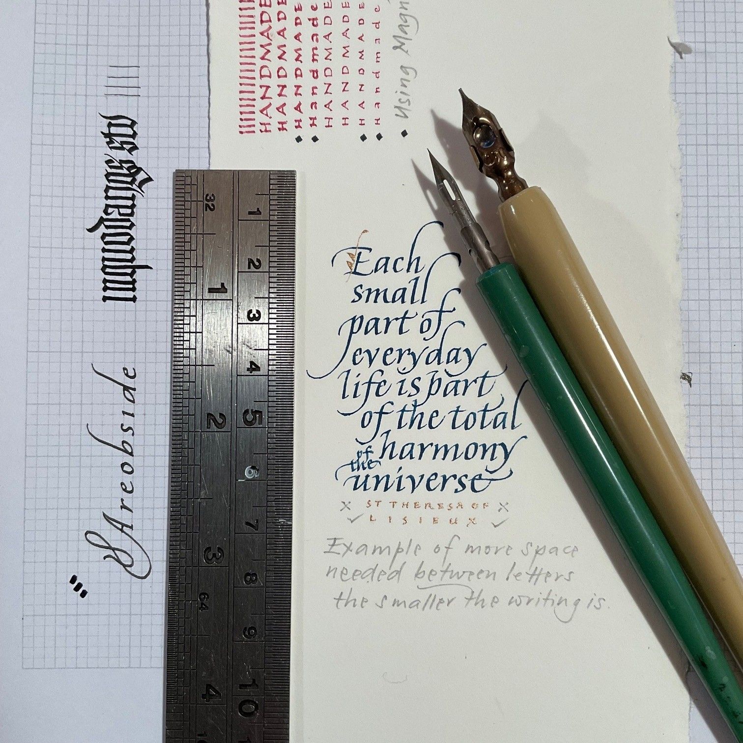 Calligraphy tools dip pens, metal ruler, paper, handwritten lettering
