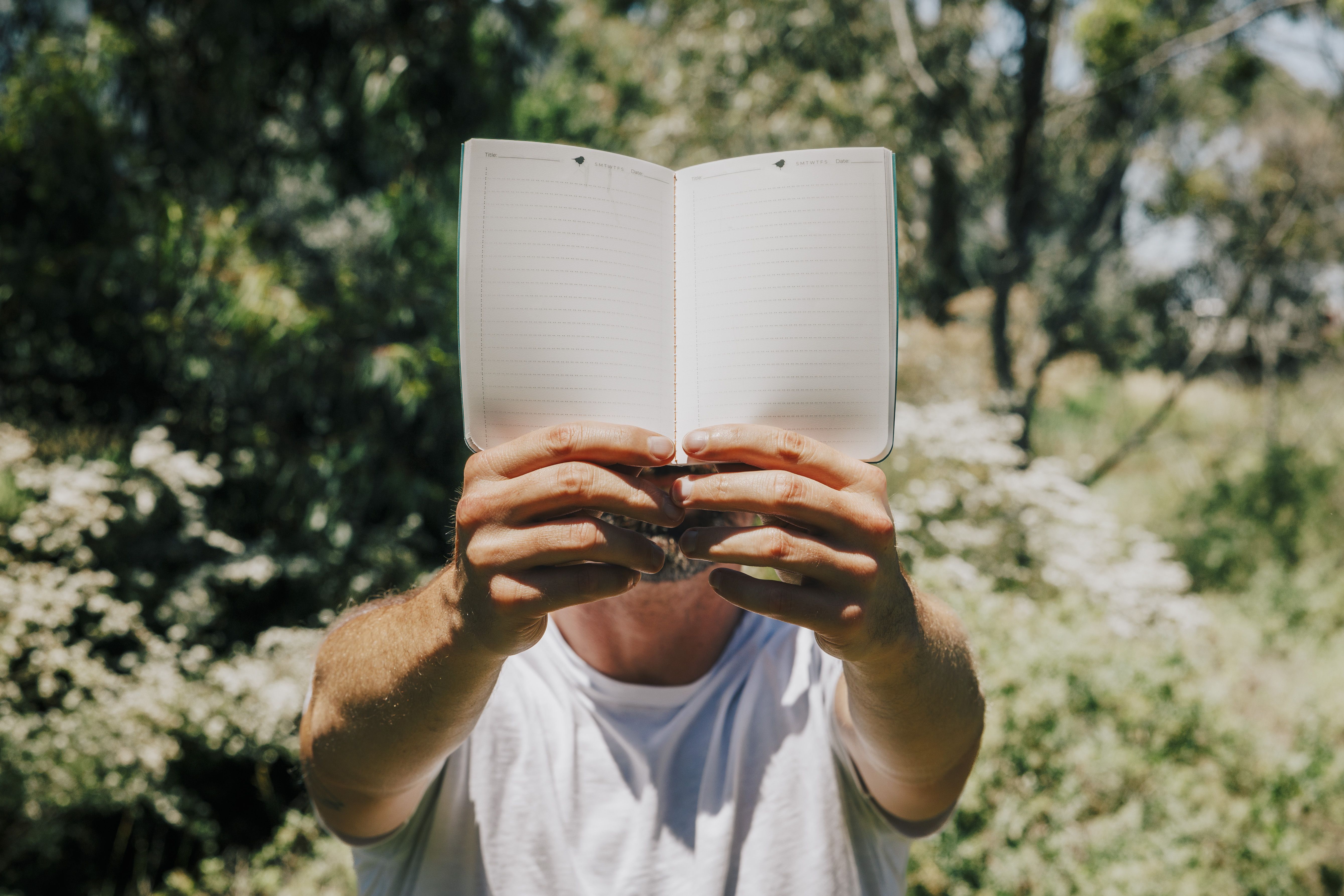 Person holding up LYFER field notebook