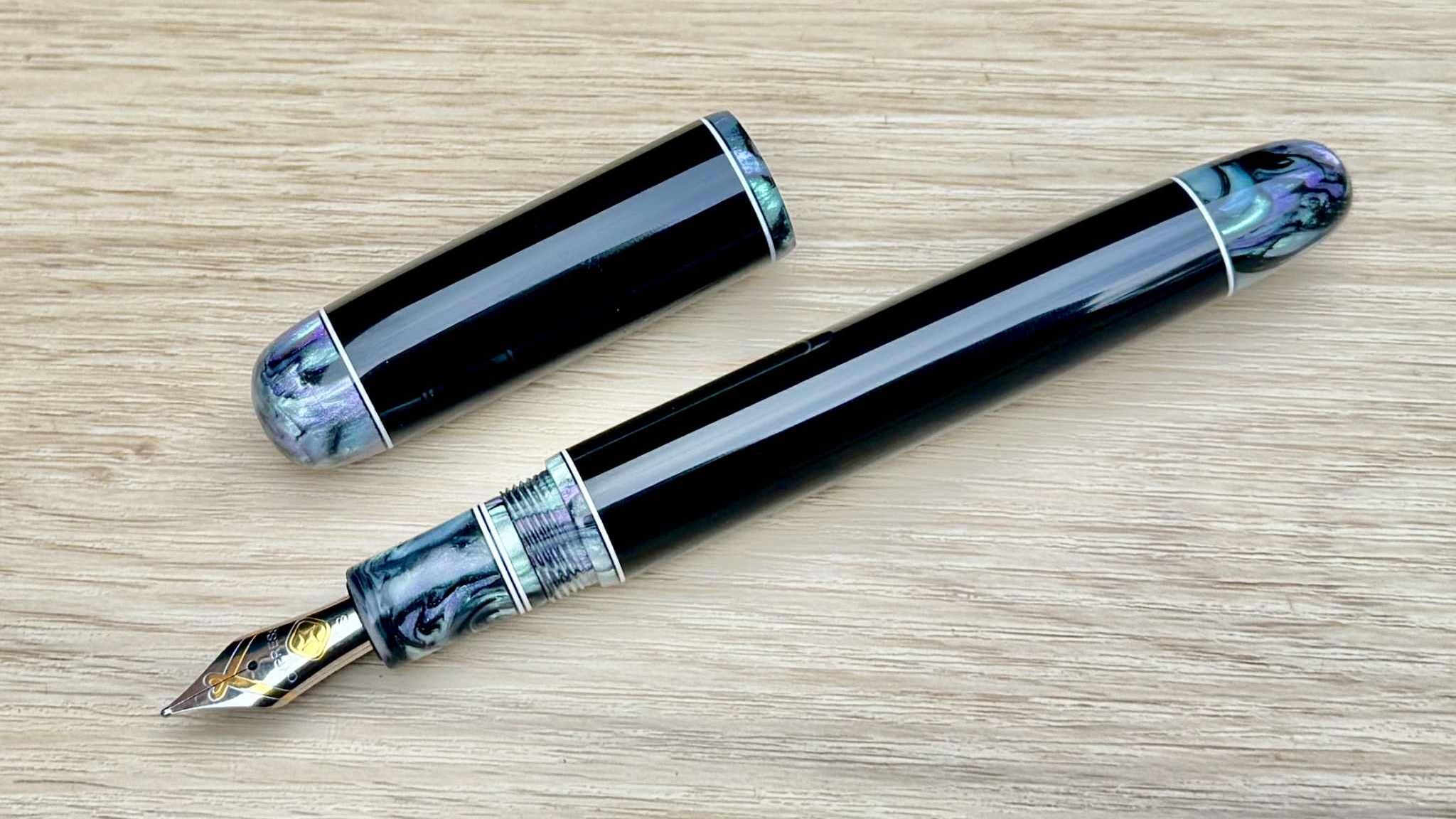 black fountain pen with inky blue black and white finials and section
