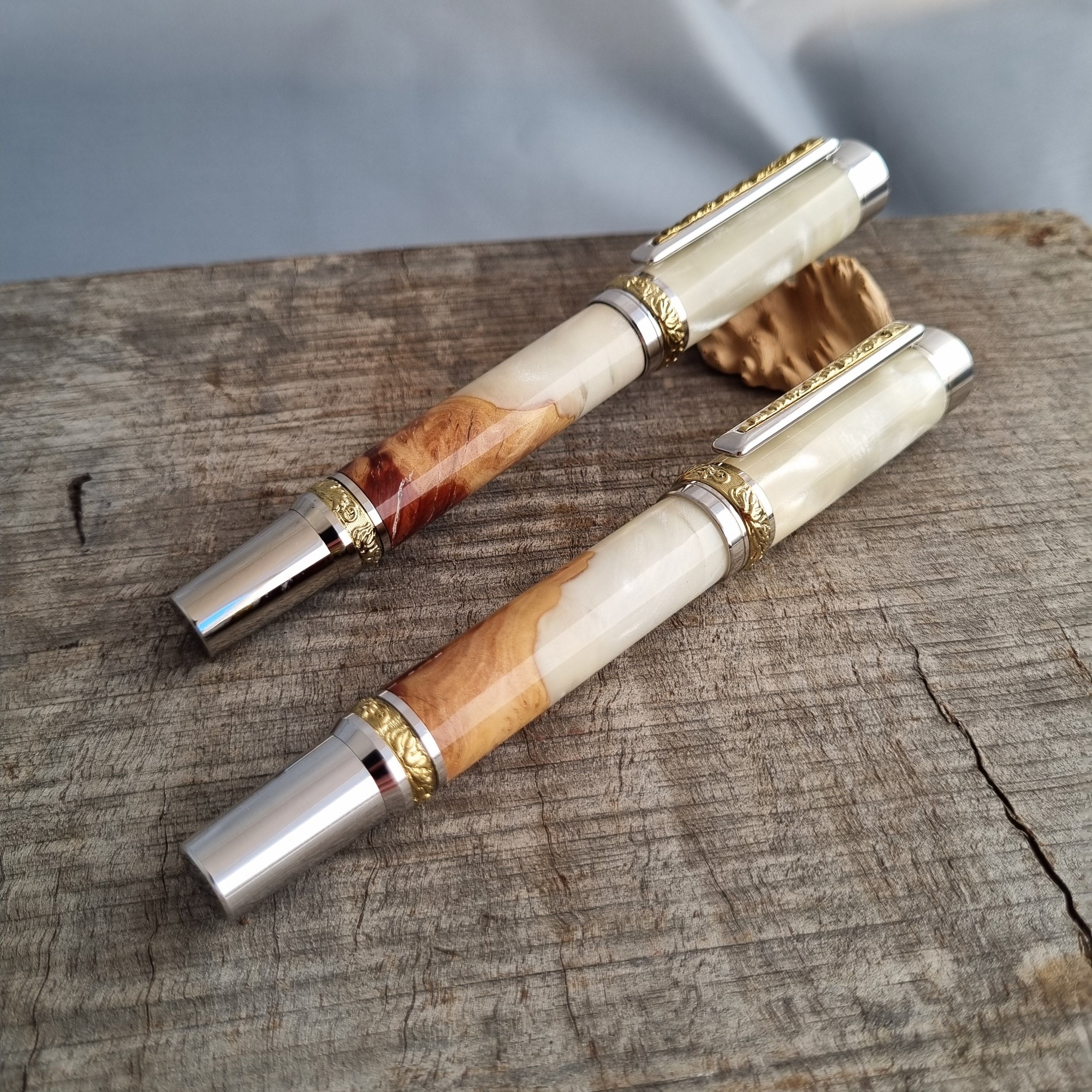 two matching wood and cream resin pens