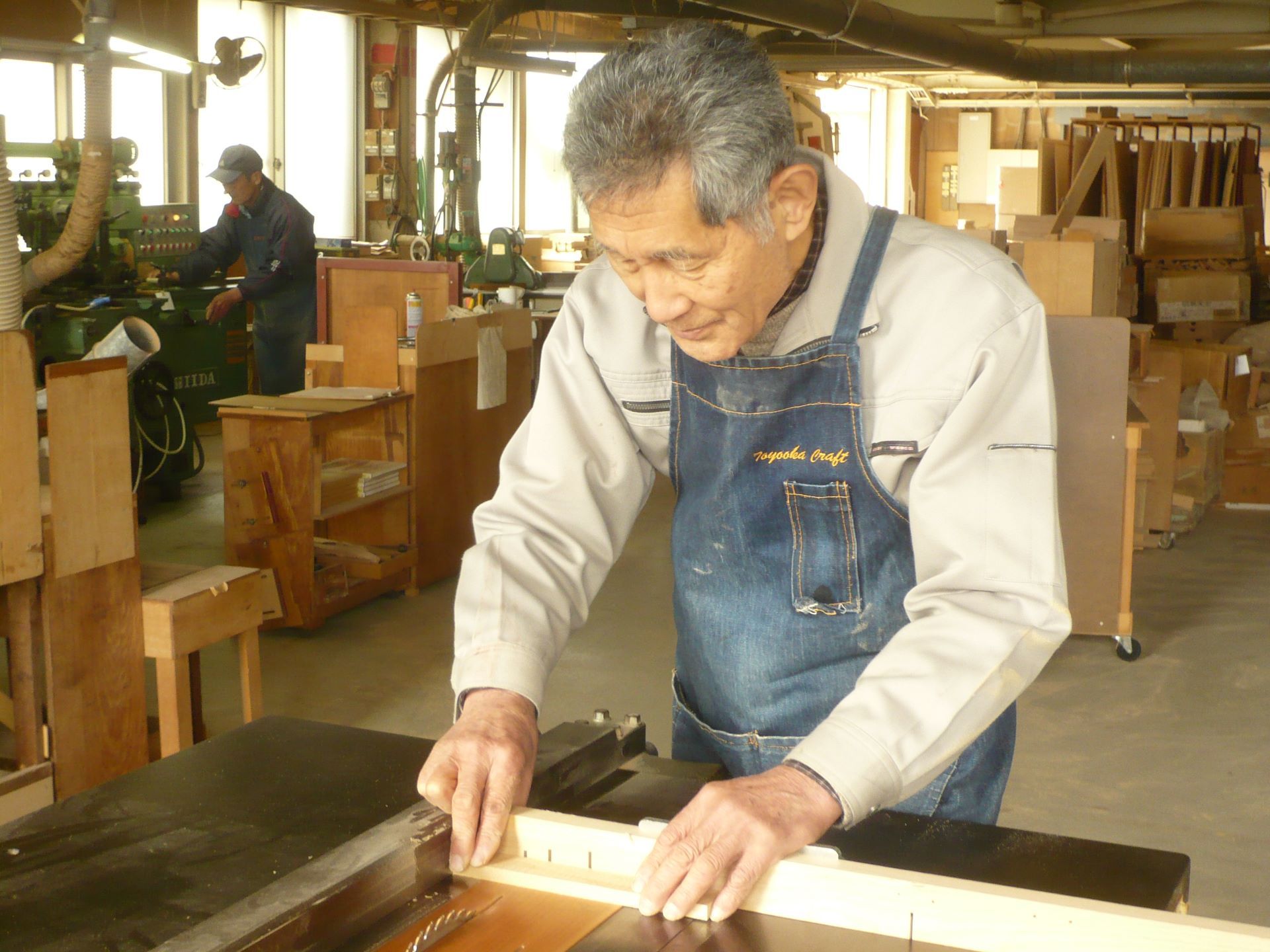 Toyooka Craftsman working on assembling Hinoki wood item