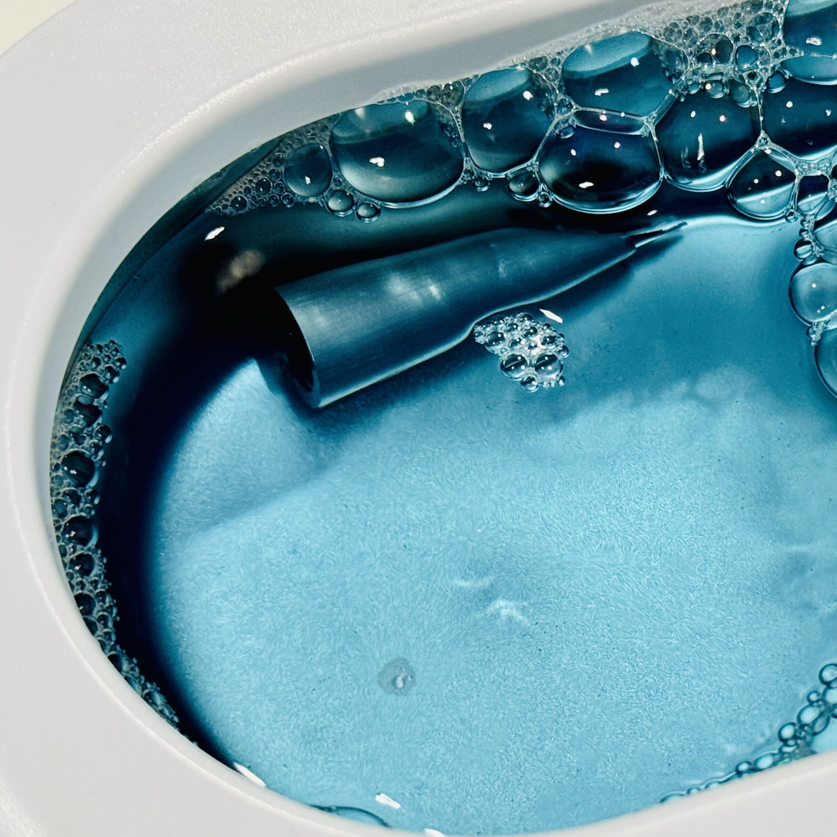 Schon Monoc titanium nib being cleaned in an ultrasonic bath.