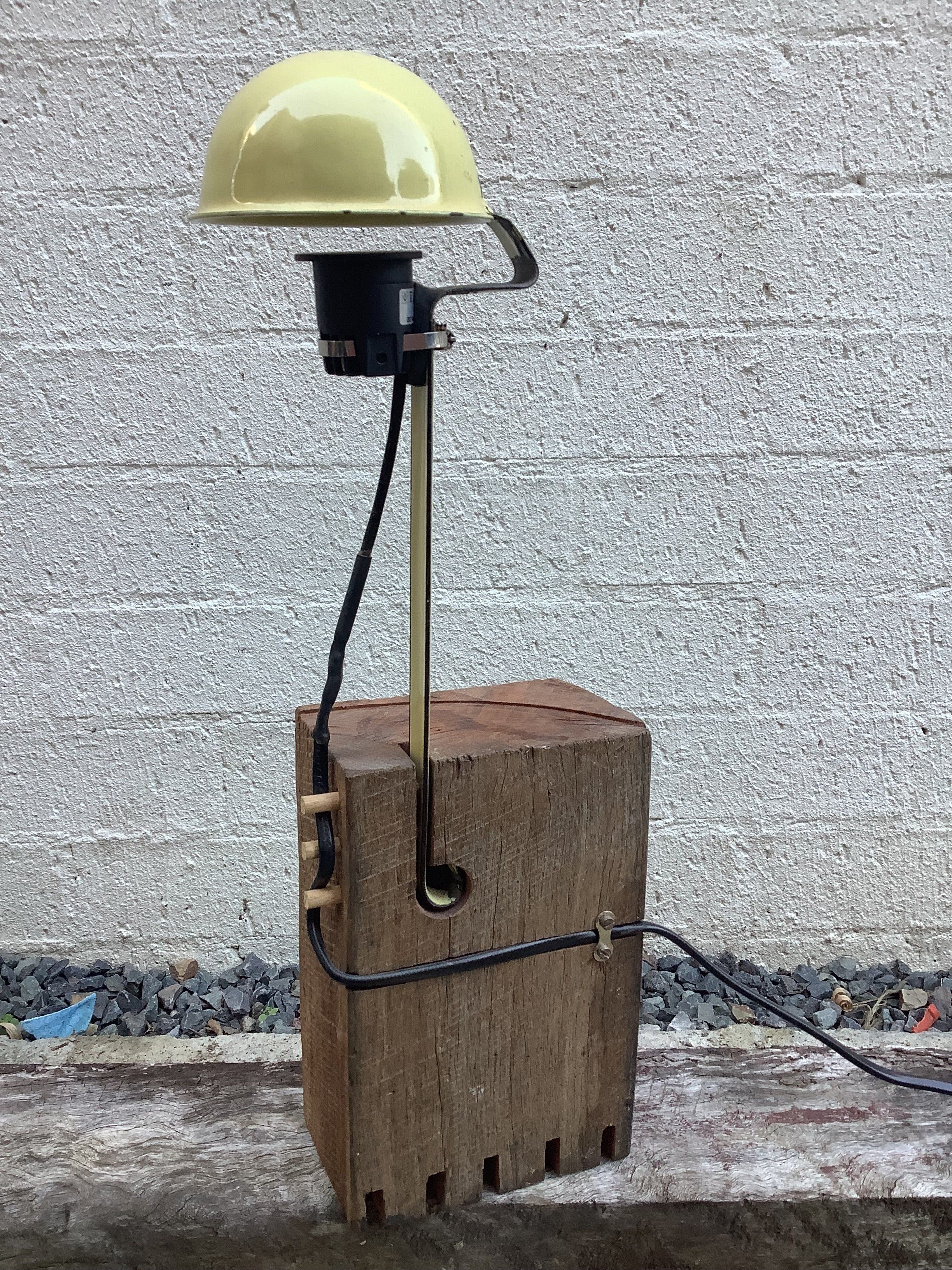 a lamp with a base made of reclaimed timber