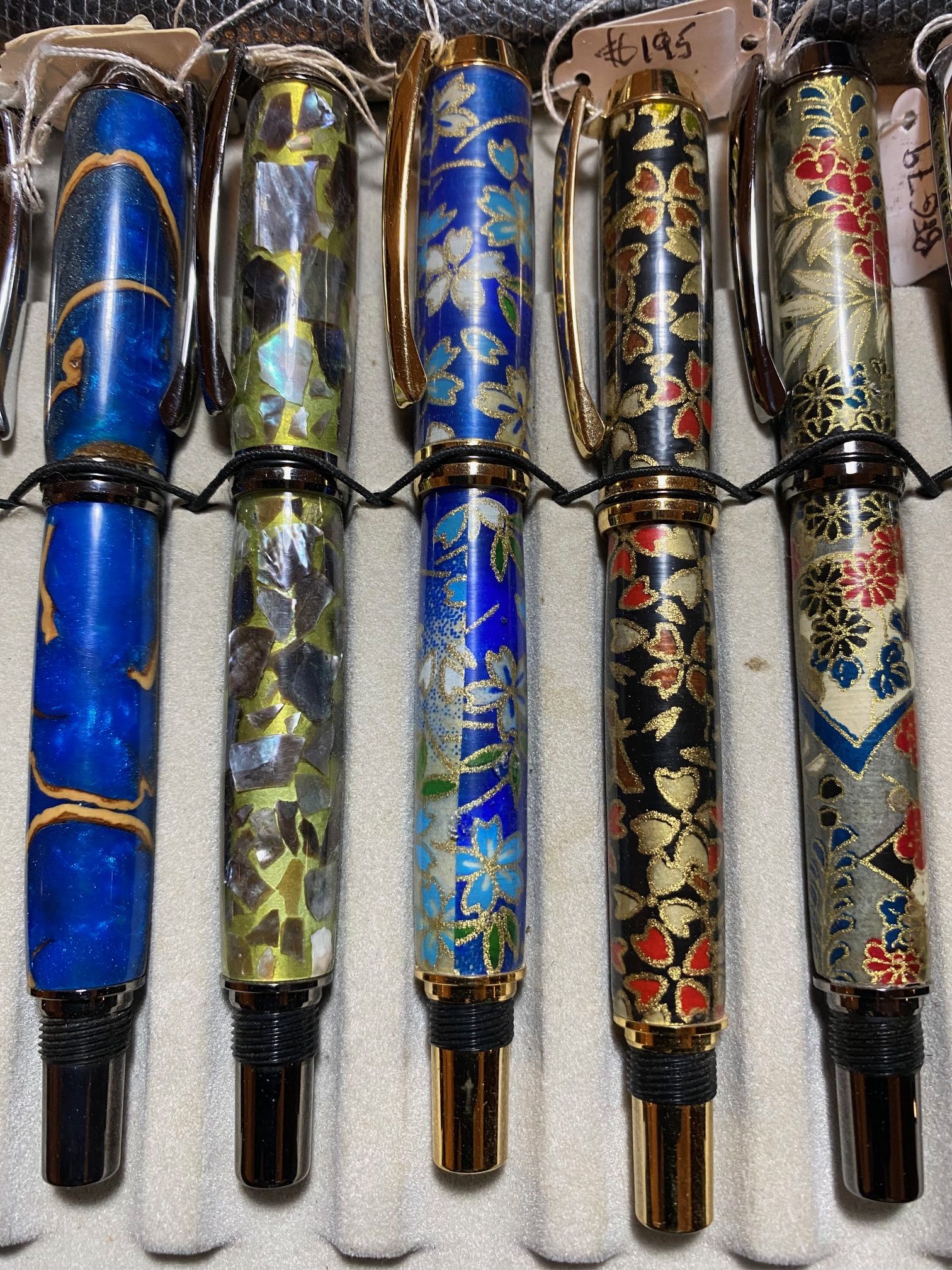 Five bespoke fountain pens on a pen tray