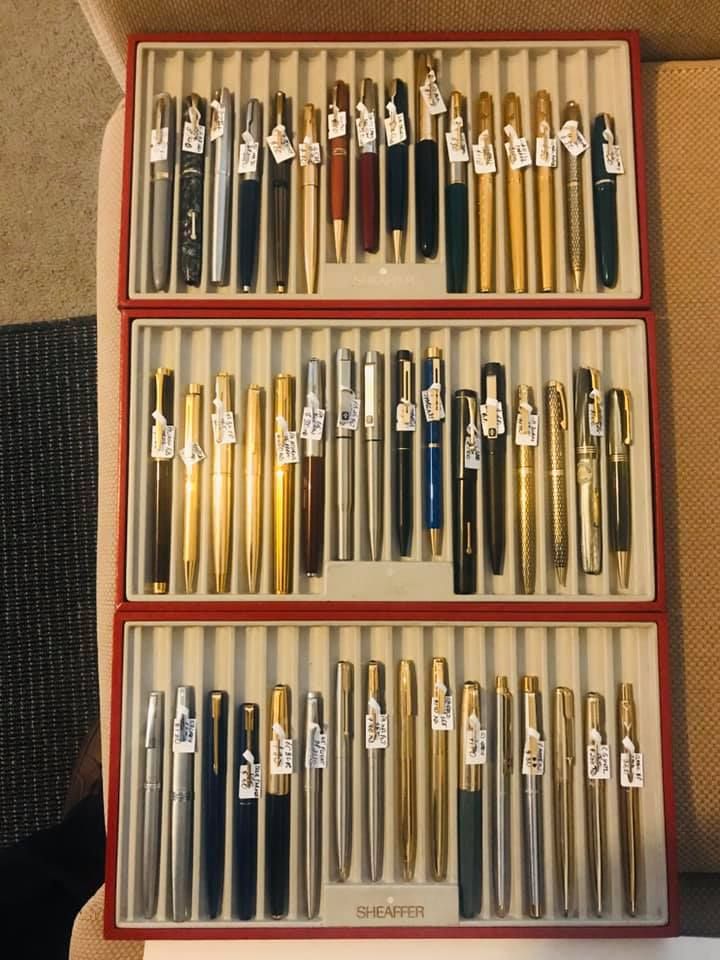 a large tray of pens with price tags