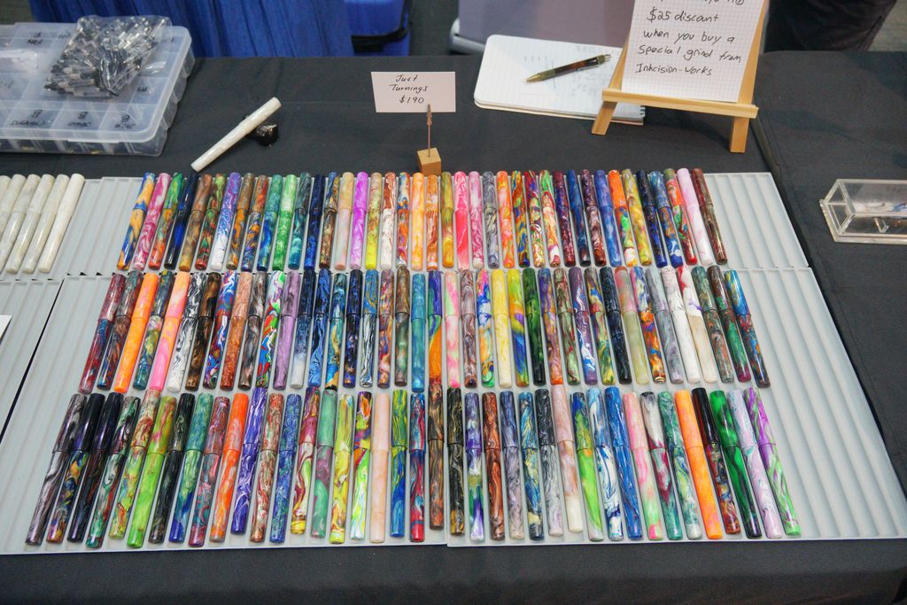 A tray with three rows of colourful, resin pens