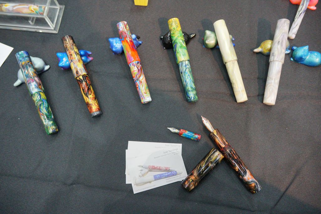 Colourful, swirly resin pens on a black table cloth