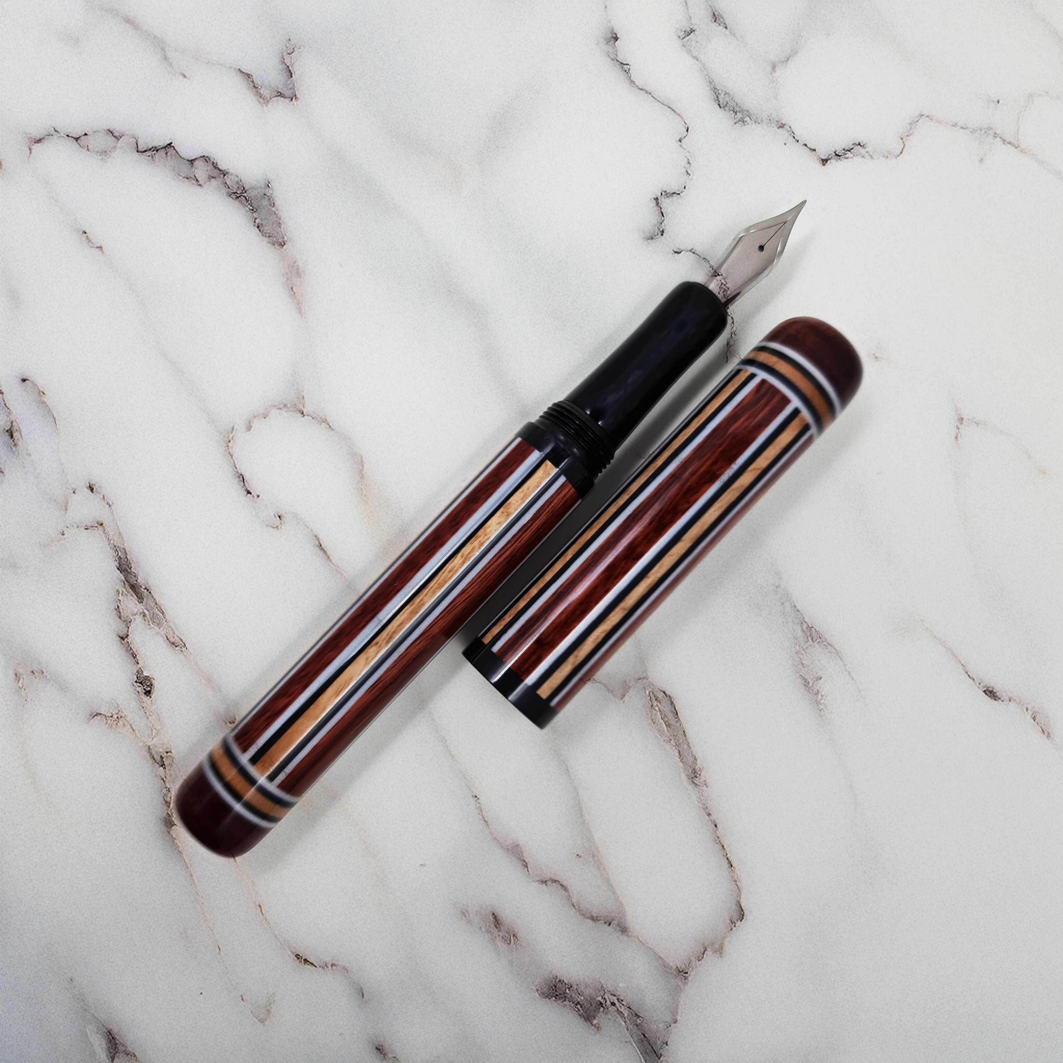 Resin multi-coloured stripy fountain pen that looks like pyjamas