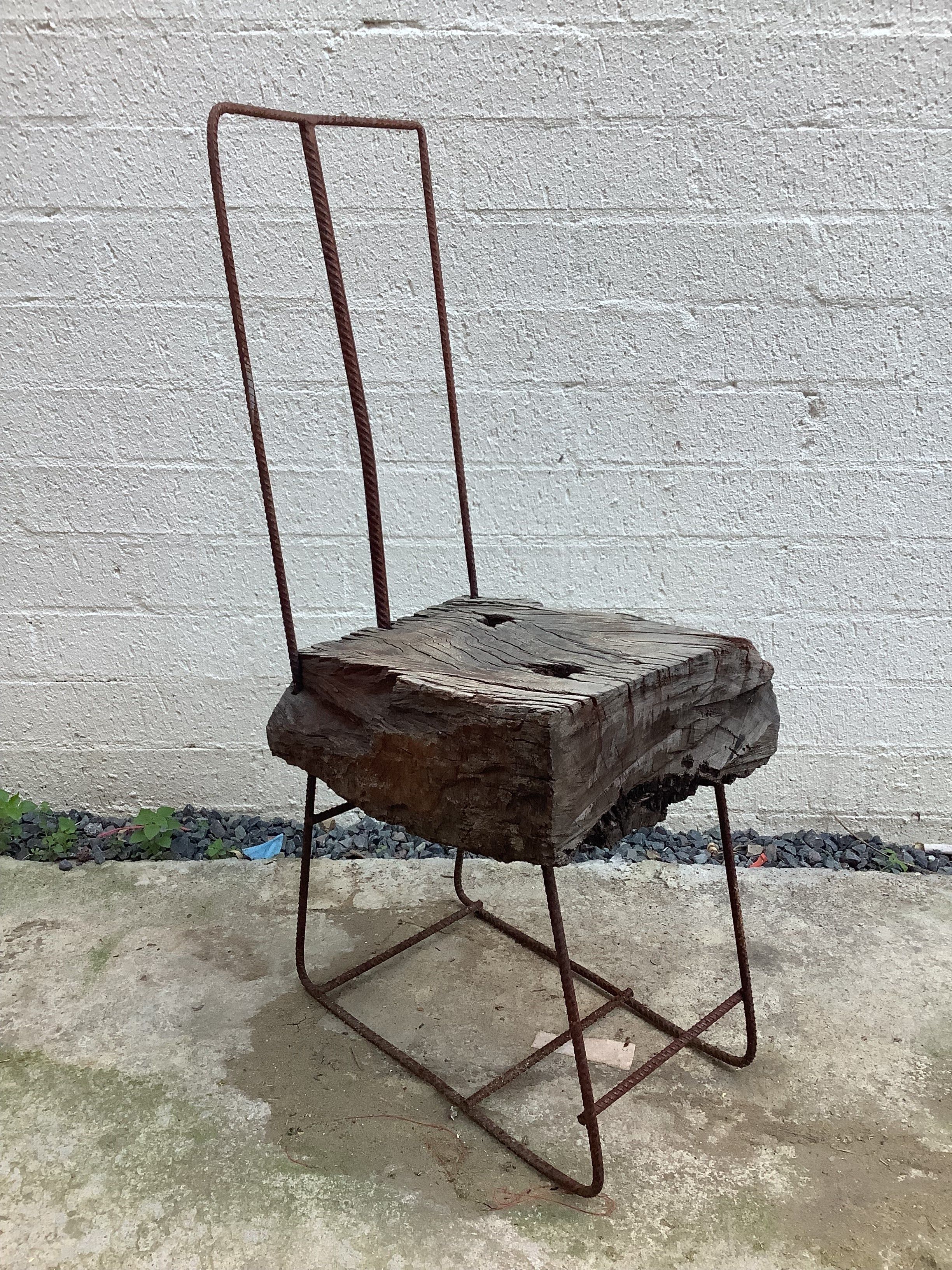 a chair made of weathered steel and reclaimed timber