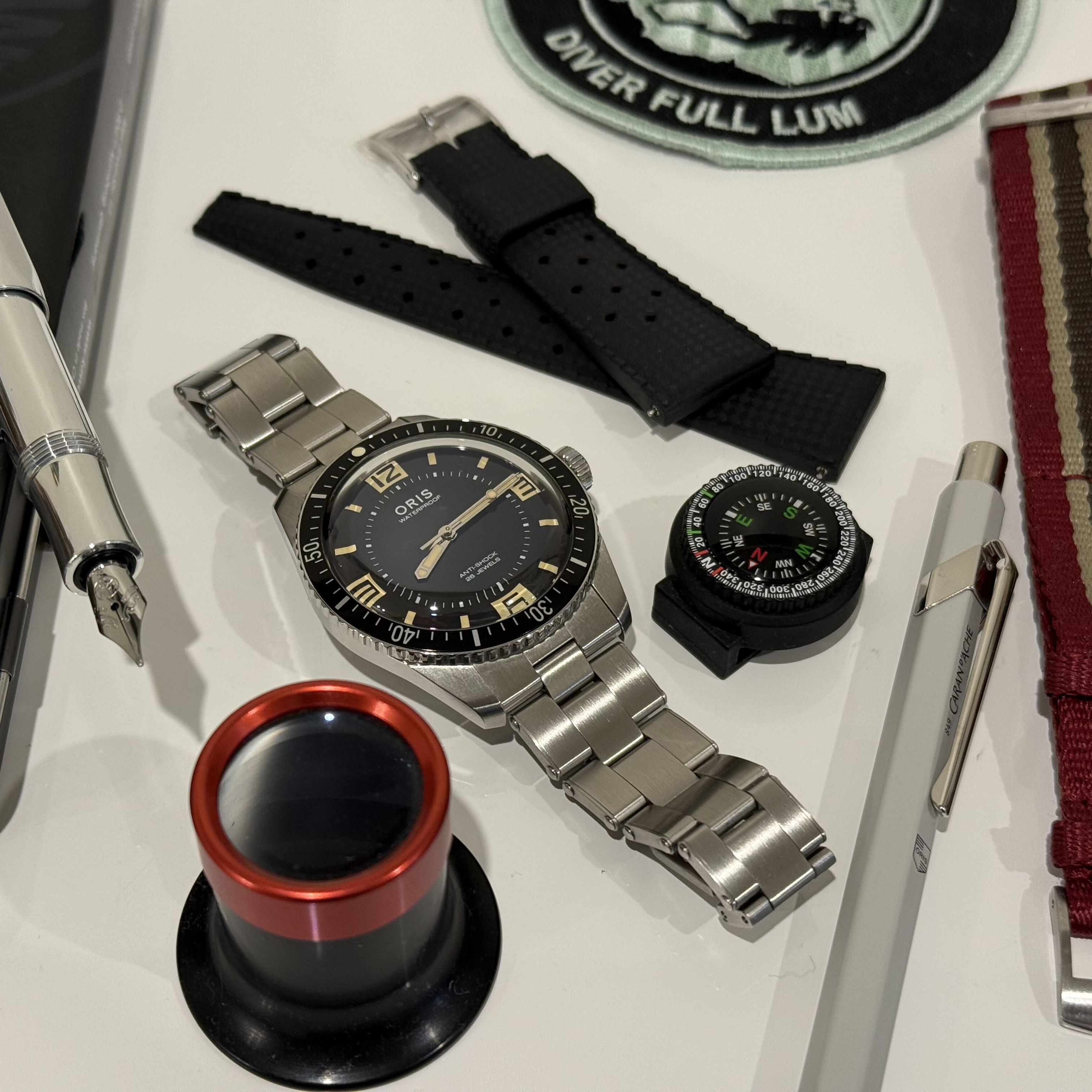 watch, straps, pen, loupe, patch