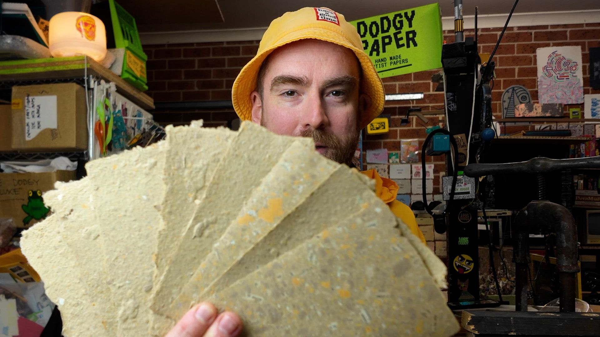 Roger holding up cream coloured recycled paper