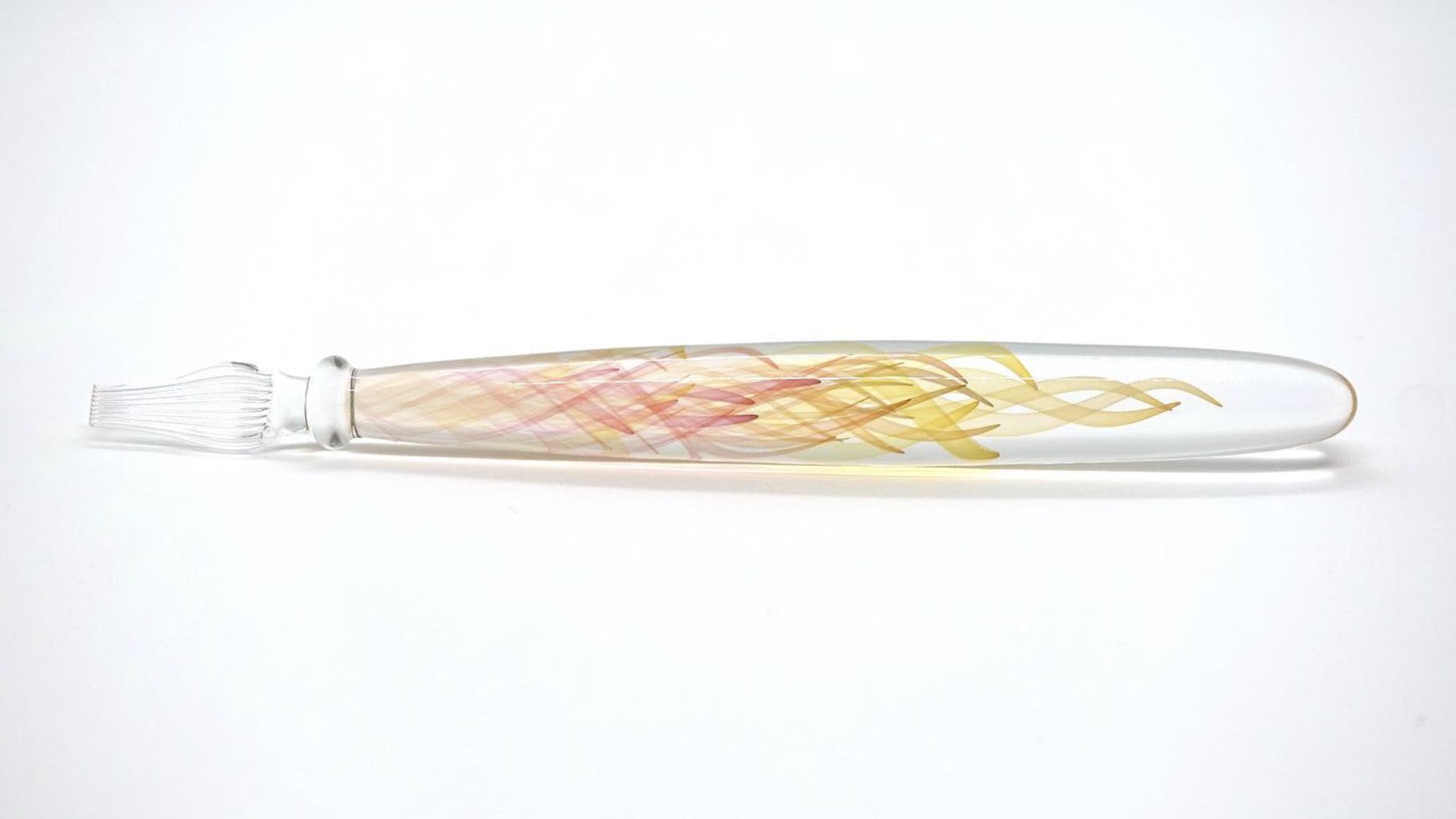 Borosilicate glass dip pen with peach and yellow double helix spirals on white