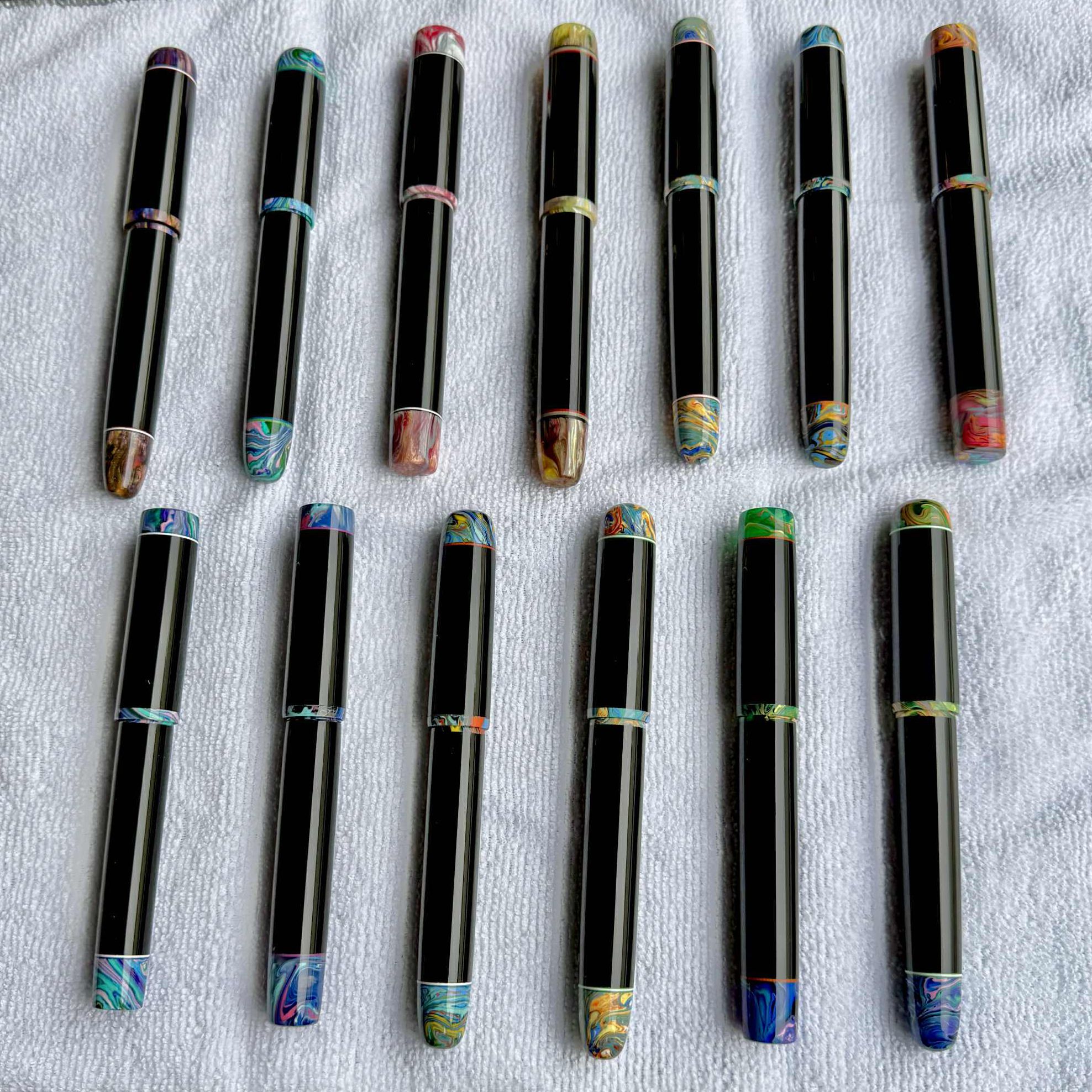 Various Fountain pens lined up on microfibre cloth