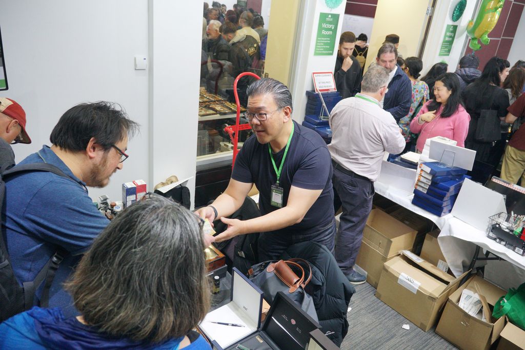 An exhibitor takes money from a visitor