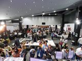 A wide view of the busy show floor from above