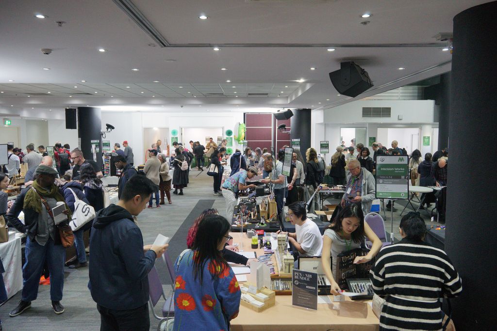 A crowded room with many exhibitor tables