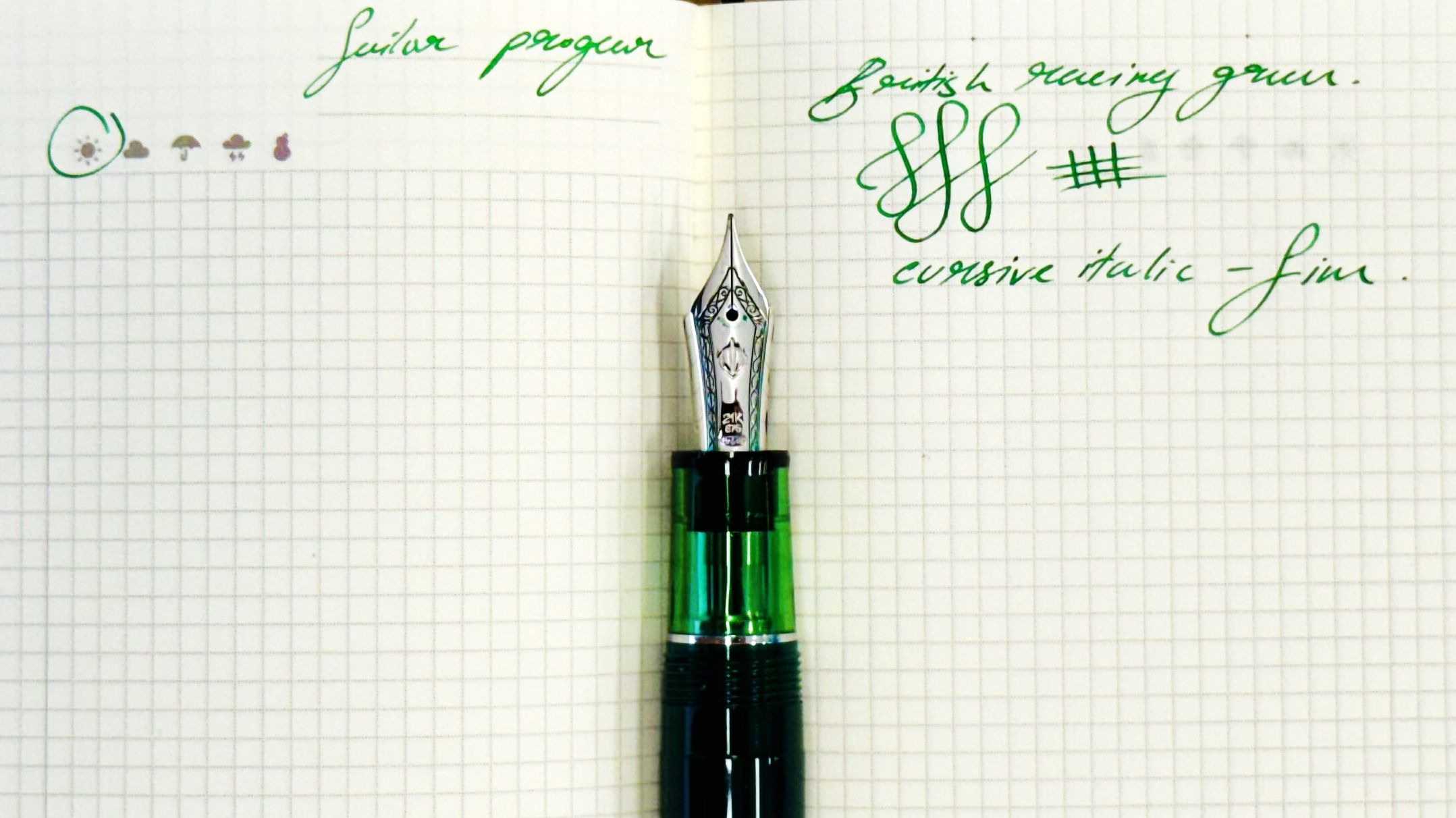 Green Sailor Pro Gear fountain pen laying in the gutter of an open Hobonichi notebook, with green ink test handwriting