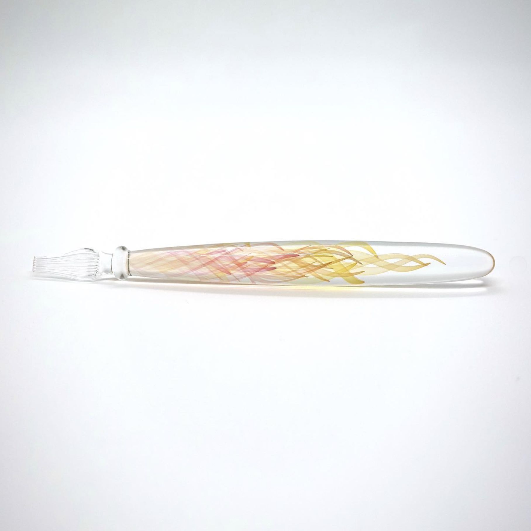Borosilicate glass dip pen with peach and yellow double helix spirals on white